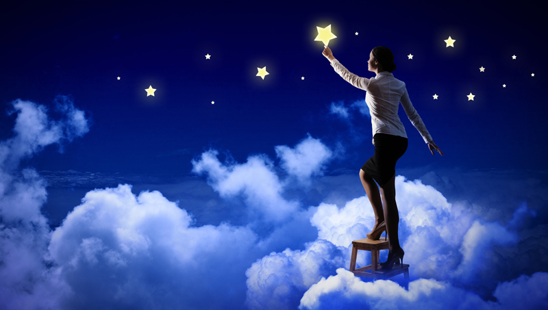 Woman reaching for a star